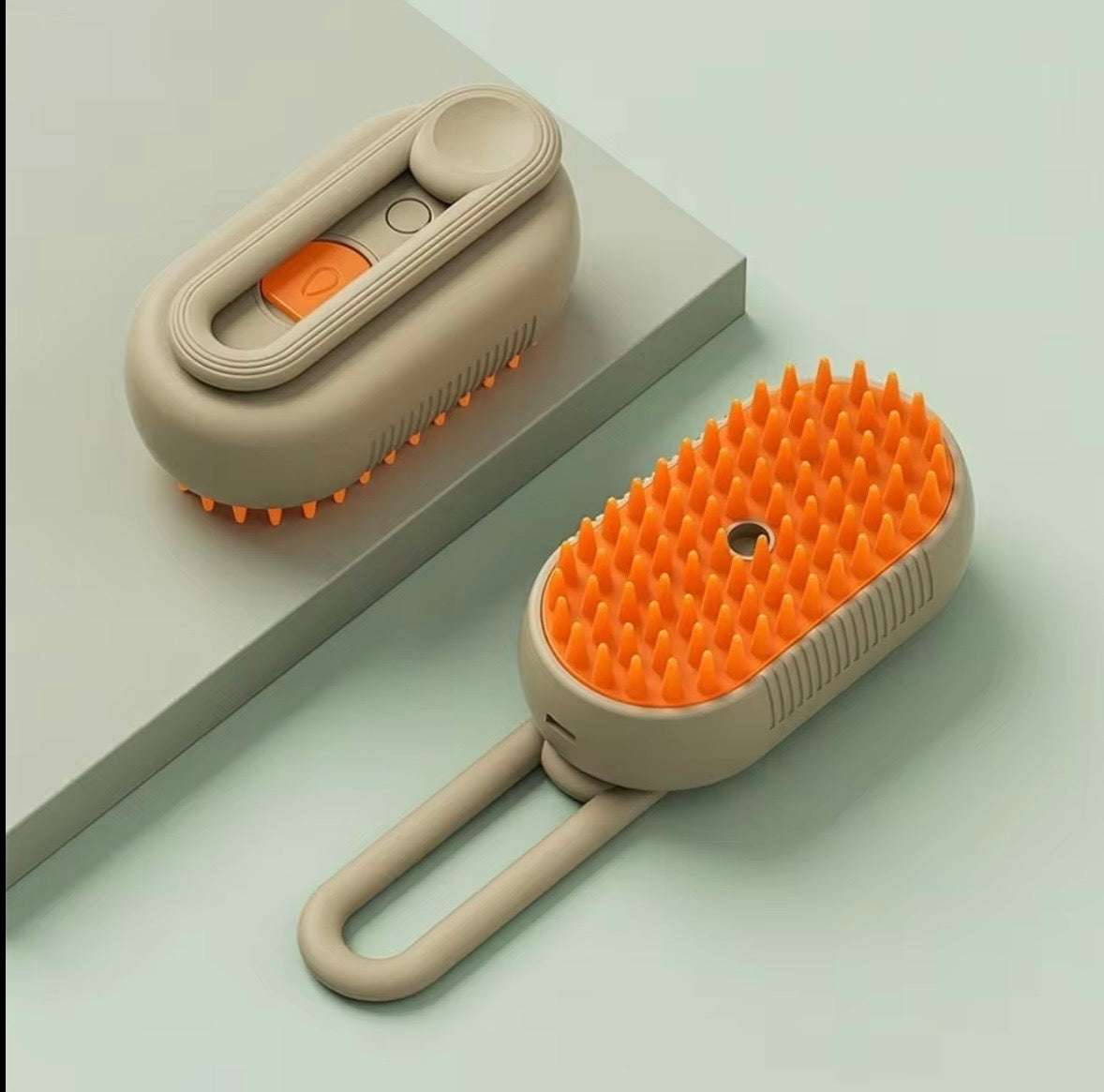 3-in-1 electric steamy pet grooming brush, featuring a rechargeable design with a khaki handle and orange silicone bristles.