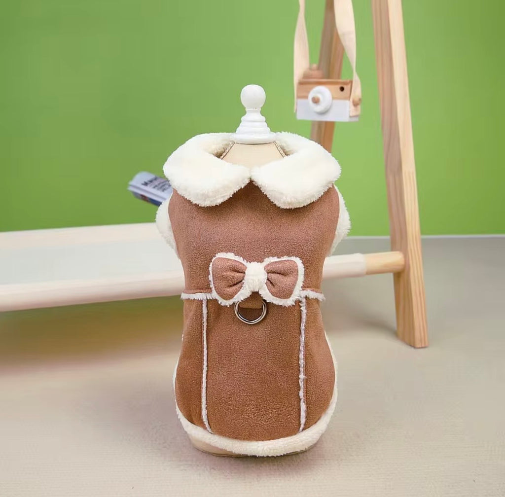 Jecikelon brand beige suede winter coat for small dogs featuring a white fleece lining, turtleneck collar, and decorative bow tie.