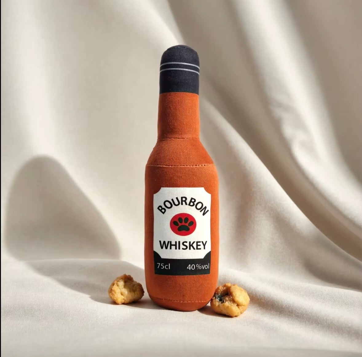 plush, squeaky bottle-shaped toys designed for dogs and cats, featuring various liquor and wine brand parodies.