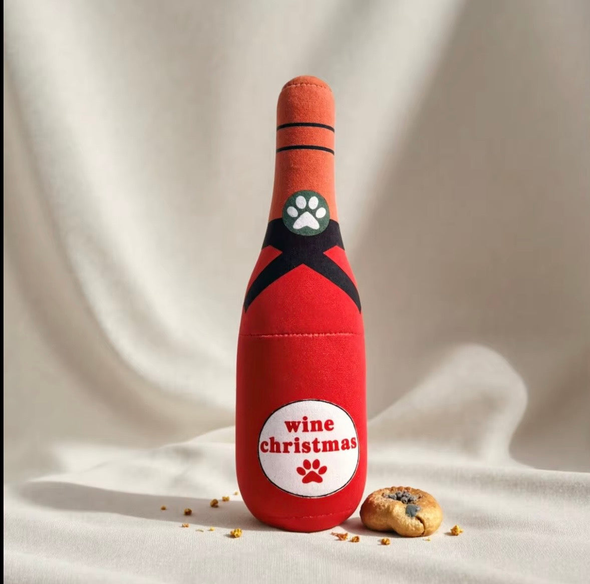 plush, squeaky bottle-shaped toys designed for dogs and cats, featuring various liquor and wine brand parodies.