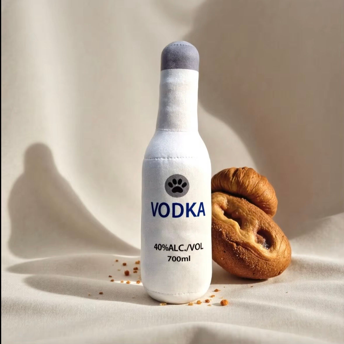 plush, squeaky bottle-shaped toys designed for dogs and cats, featuring various liquor and wine brand parodies.