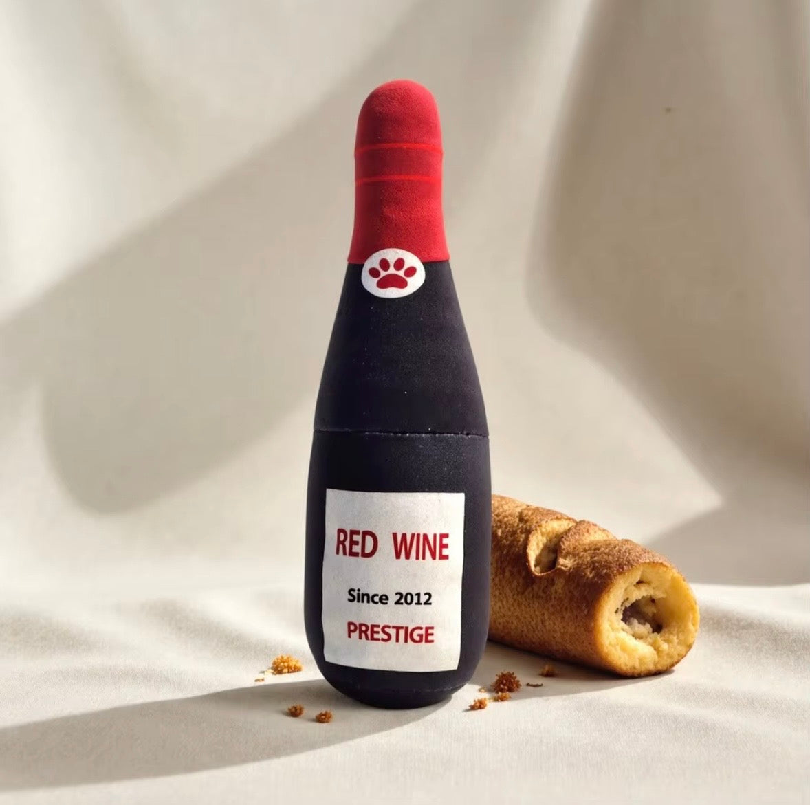 plush, squeaky bottle-shaped toys designed for dogs and cats, featuring various liquor and wine brand parodies.