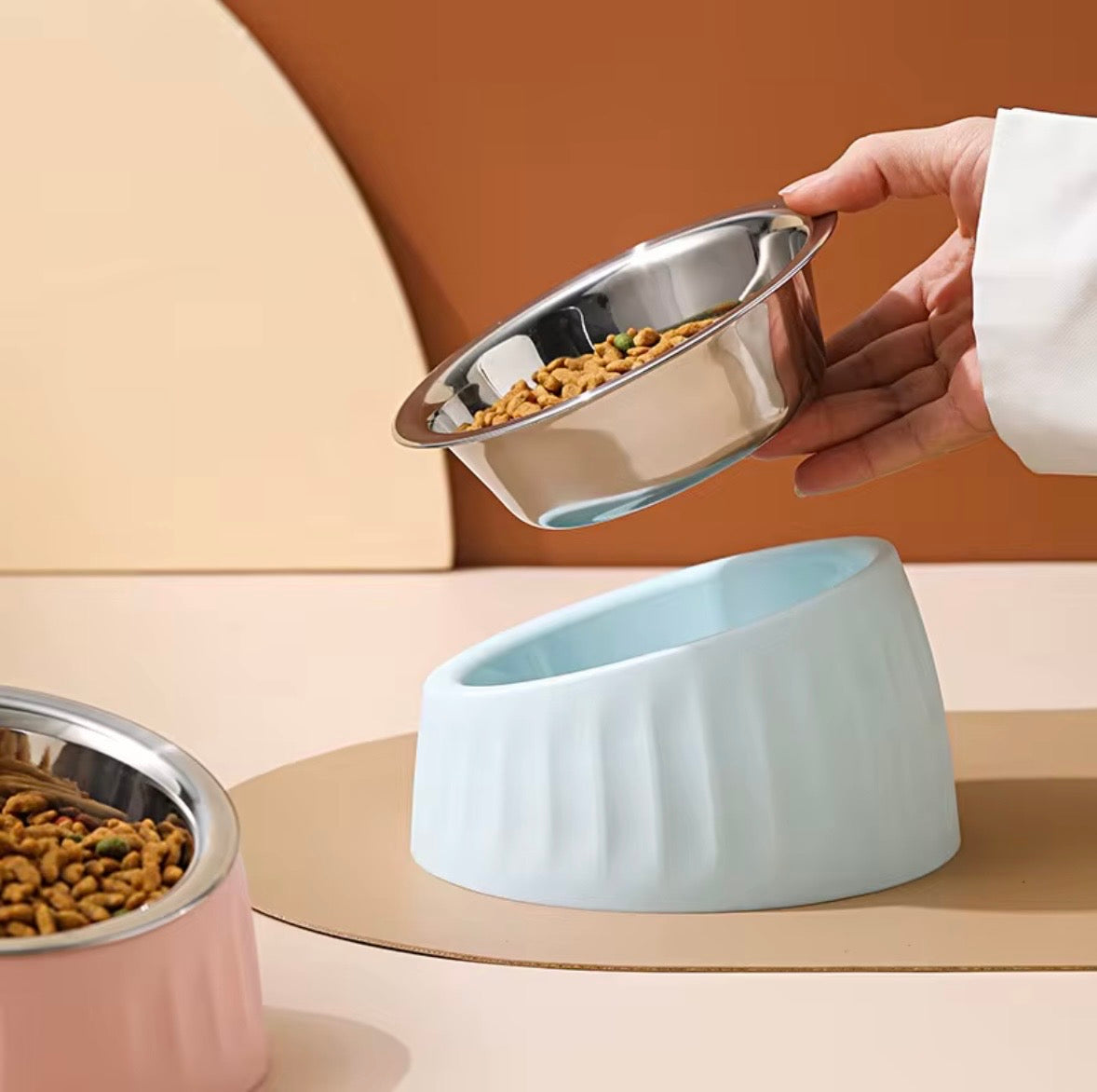 These are colorful stainless steel pet bowls with an elevated, tilted design.