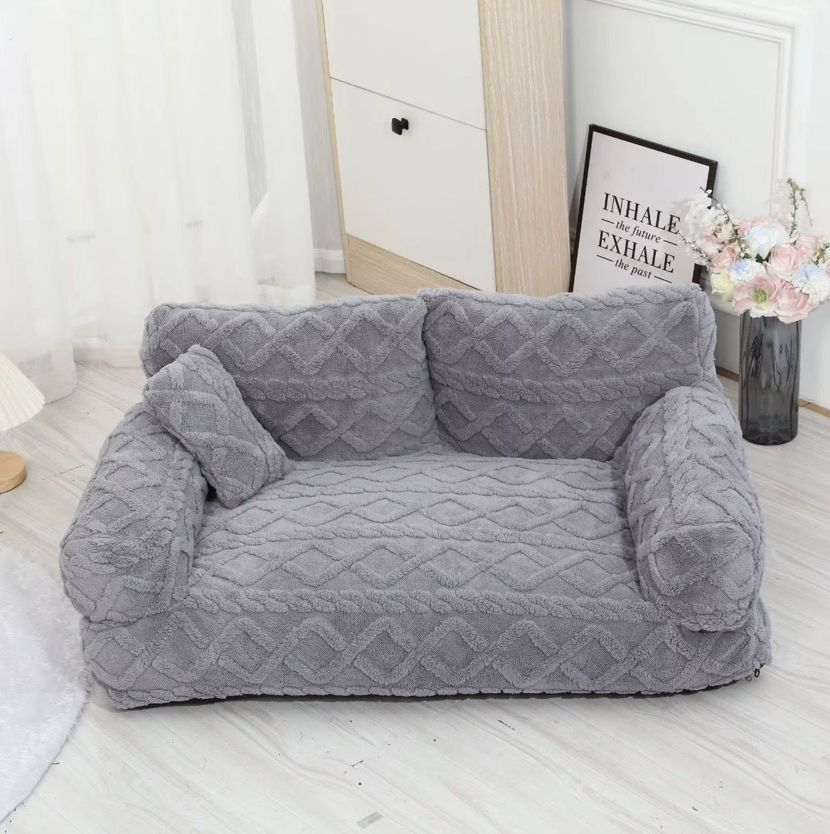This is a plush grey cuddler pet bed
