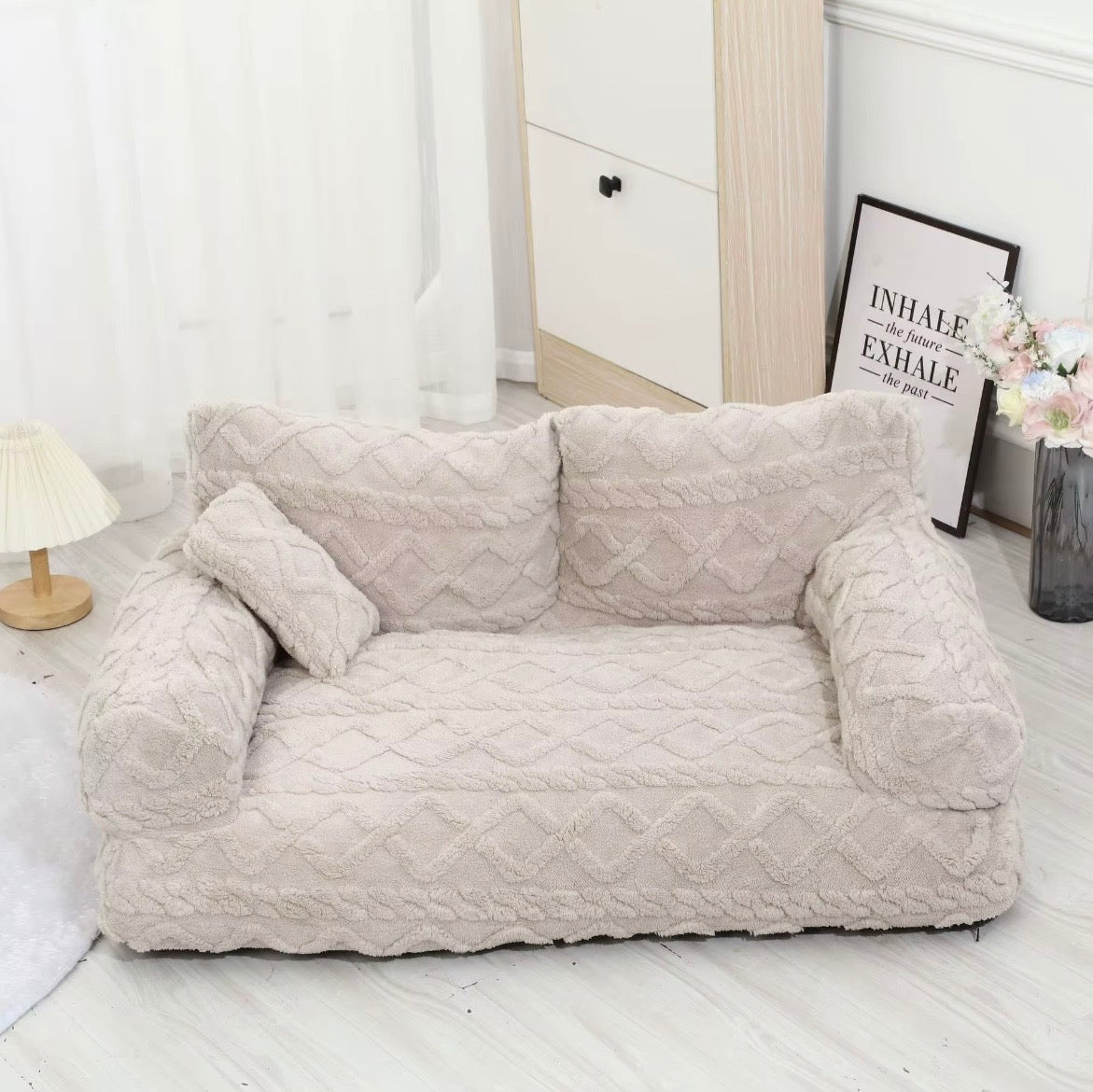 This is a plush grey cuddler pet bed