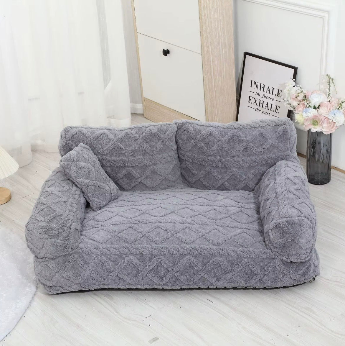This is a plush grey cuddler pet bed