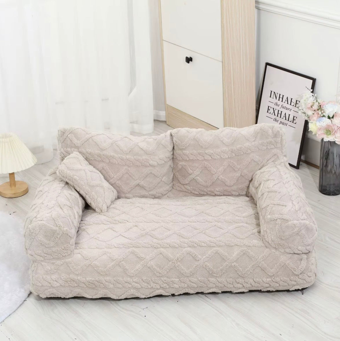 This is a plush grey cuddler pet bed