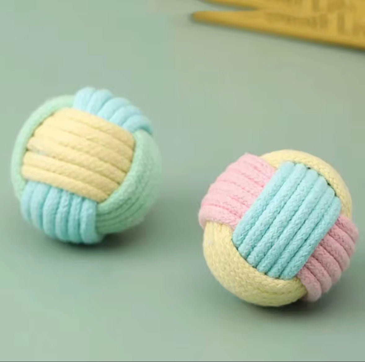 These are cotton rope cat toy balls featuring a macaron-inspired color palette.